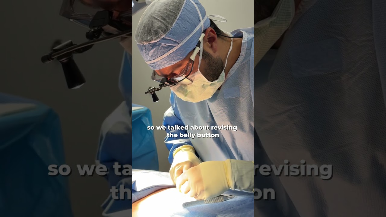 Surgeon performing belly button revision surgery.