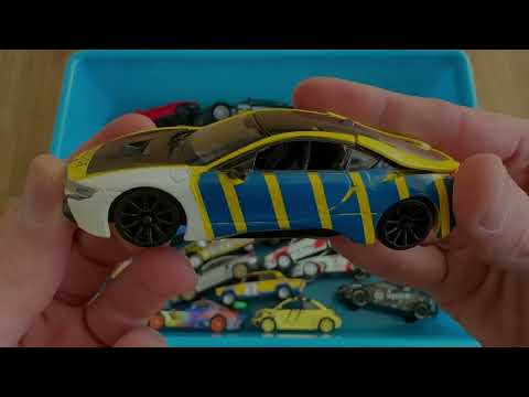 Various Small Trucks And Small Diecast Model Cars From A blue Box