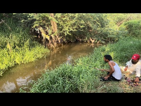 Fisherman fishing under trees due to summer heat and enjoying fishing