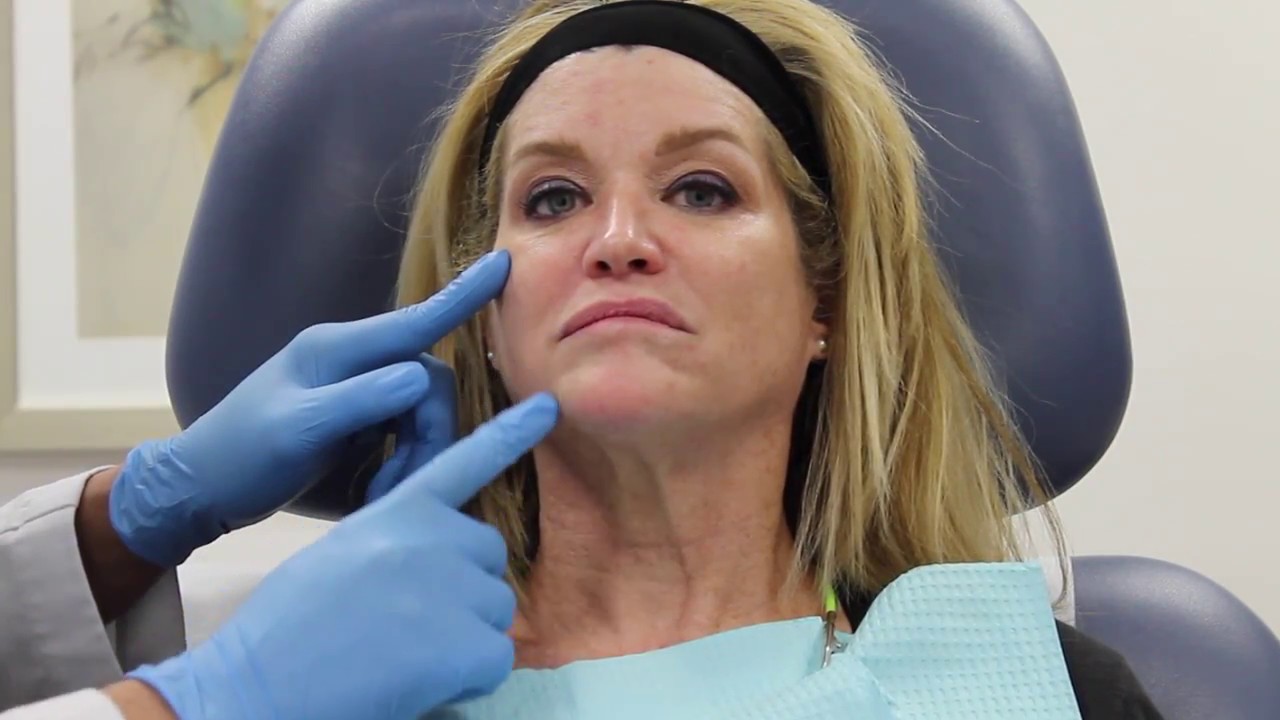 Patient receiving facial treatment in clinic setting.