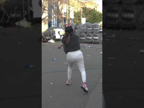 Protesters throw bricks at riot police