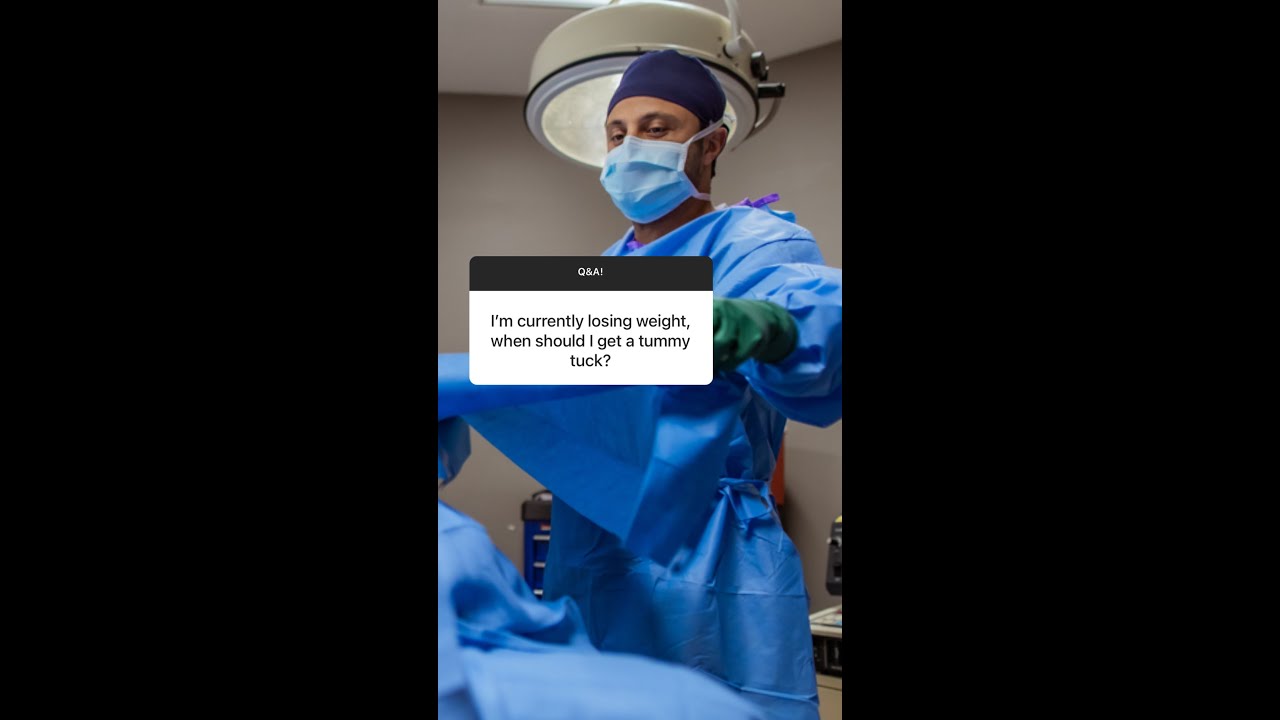 Surgeon addressing tummy tuck questions during consultation.