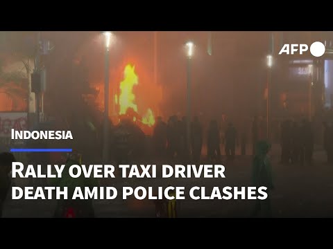 Protesters set fires in Jakarta as they rally over taxi driver's death | AFP