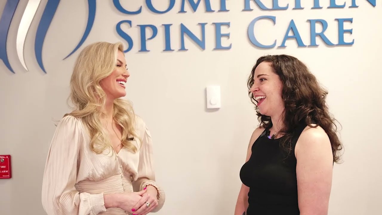 Two women smiling at a healthcare facility.