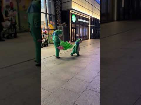 Child runs crying after being chased by another in frog costume