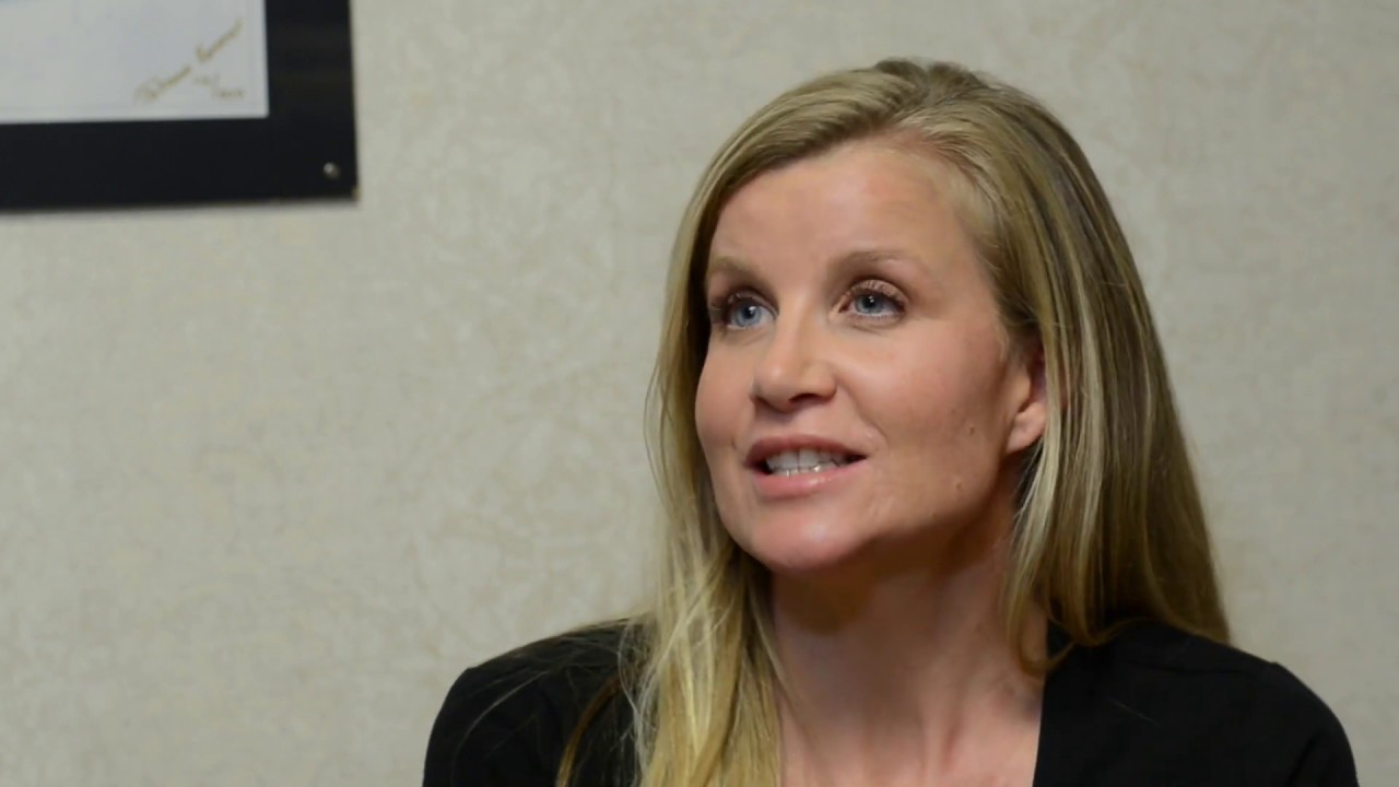 Woman speaking with a thoughtful expression.