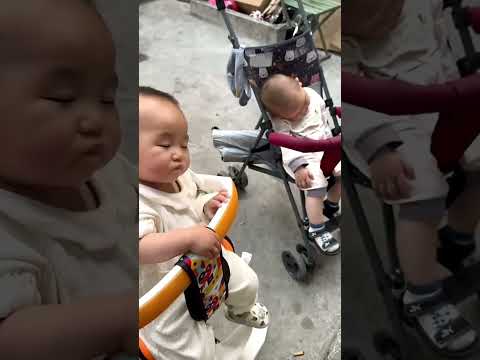 The two brothers were tired from shopping and looked at their two sleepy babies.