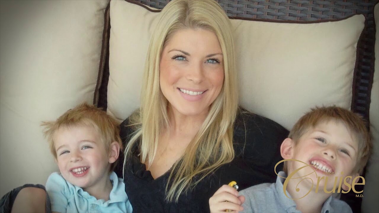 Woman smiling with two young boys.