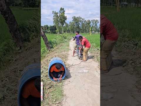 The boy is hiding inside the drum.