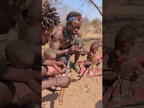 Bushmen getting delicious lunch with kids