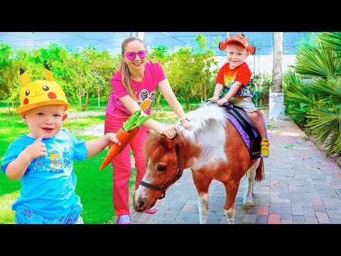 Oliver and Adam feeding the Animals on the Farm