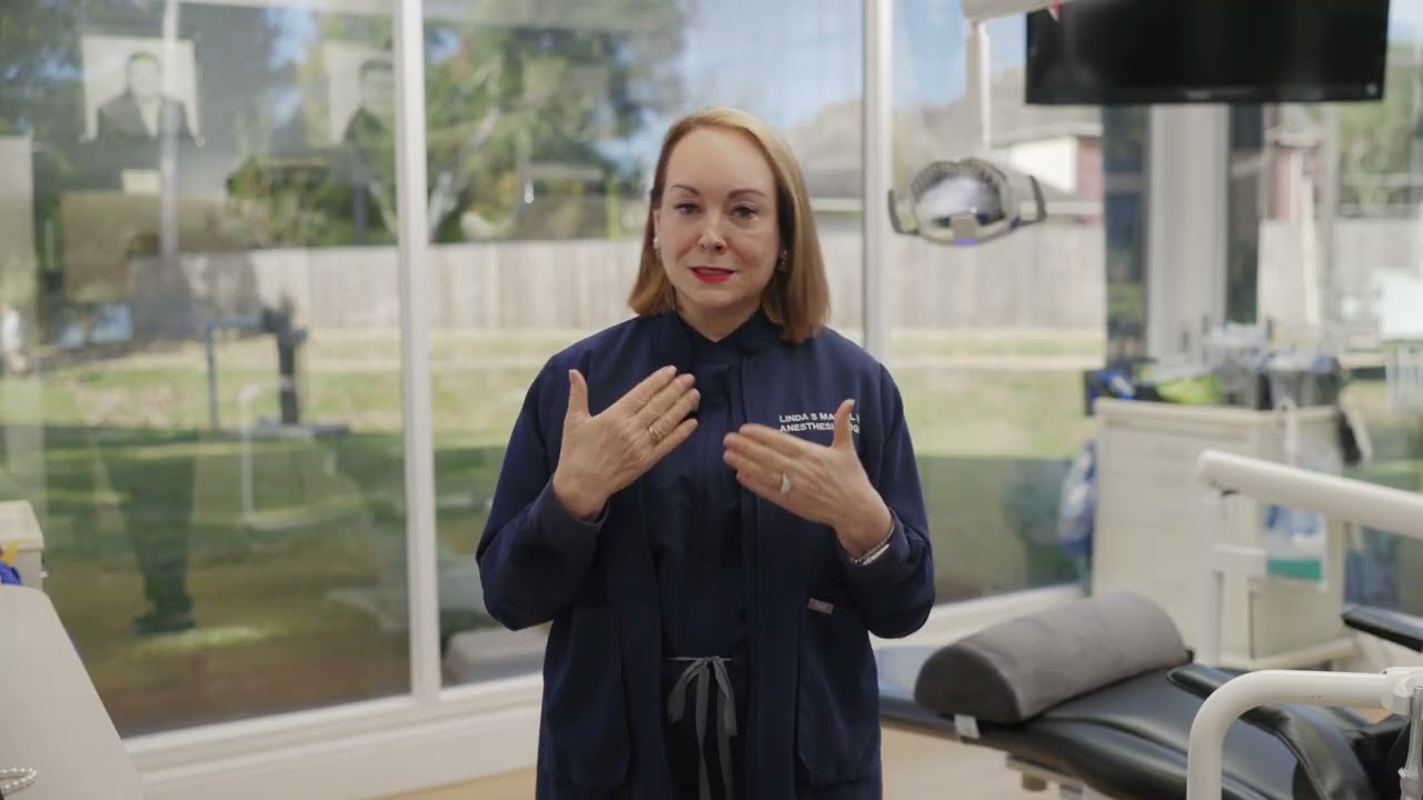 Medical professional speaking in a clinic setting.