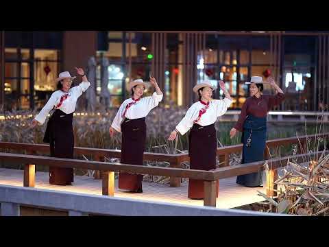 Tibetan women dancing a traditional Tibetan dance happily