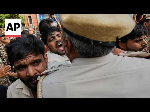 Police scuffle with members of India's Congress party in protest against election chief