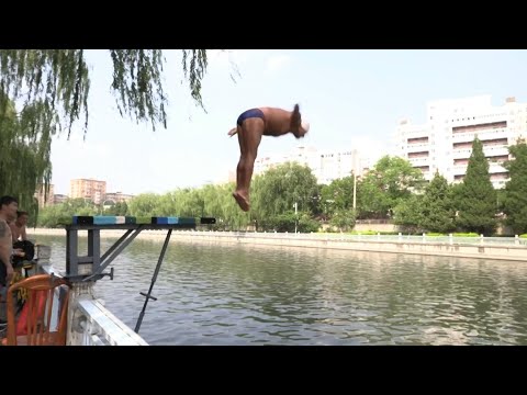 The elderly dive into Beijing river to beat soaring temperatures | AFP