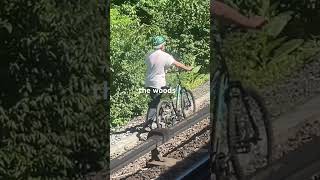 This guy walking the tracks with his bike