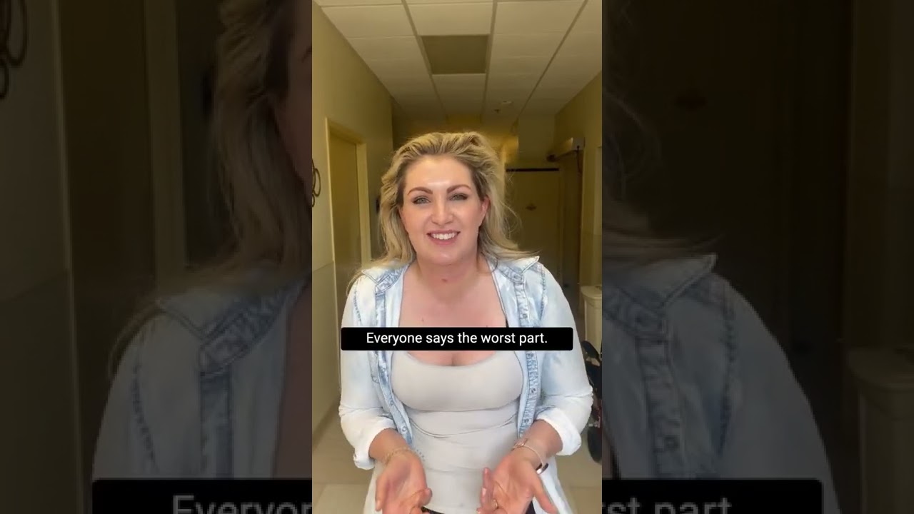 Woman speaking with a smile in a hallway.