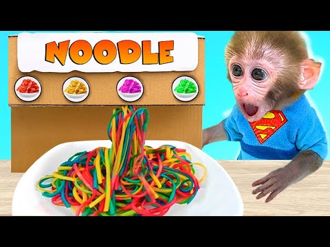 Monkey baby Bon Bon eats colorful pasta and swims with the puppy in the pool