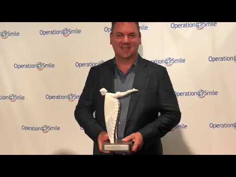 Man holding award at Operation Smile event.