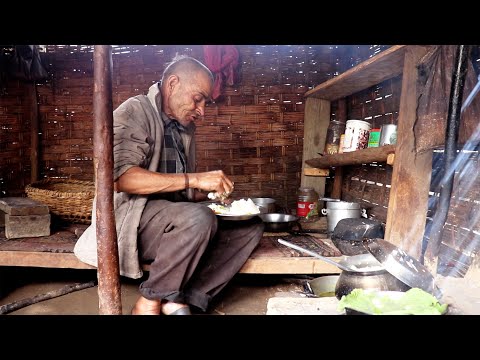 village father cooking and enjoying his lunch alone in his house