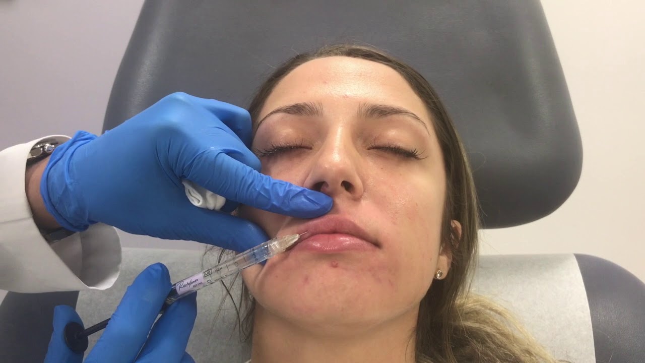 Woman receiving skincare treatment in clinical setting.