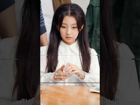 The girl pretended not knowing how to play card.