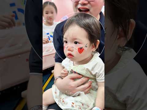 The cute little girl painted her favorite strawberry on her face.#cute#shorts