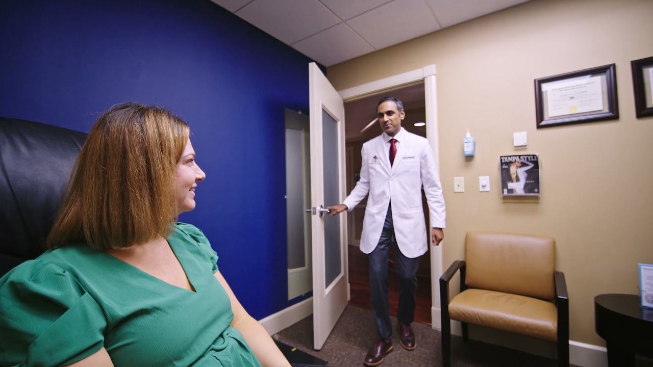 Doctor entering an examination room with patient.