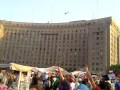 People cheering military helicopters over Tahrir Square