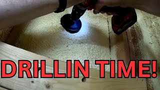 Measuring and drilling through both buildings to run a electrical wire pipe through