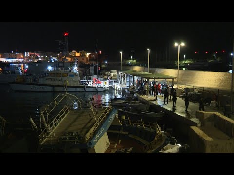Migrants disembark and receive aid off Lampedusa coast | AFP