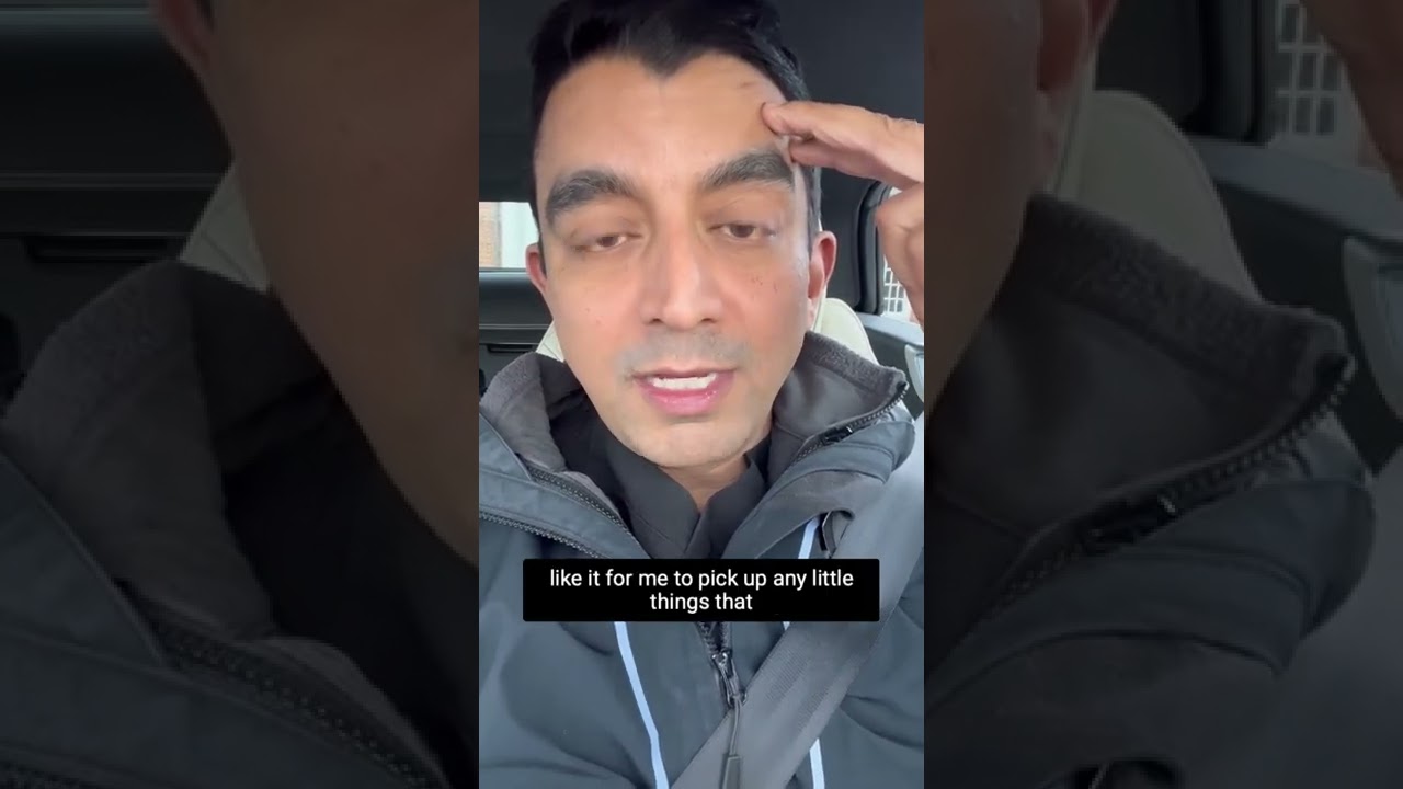 Person speaking in a car with subtitles visible.