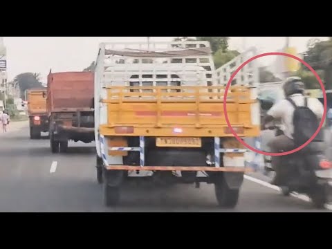 Omg bike driver insane overtaking in a narrow space n struck between tractor & truck Just miss