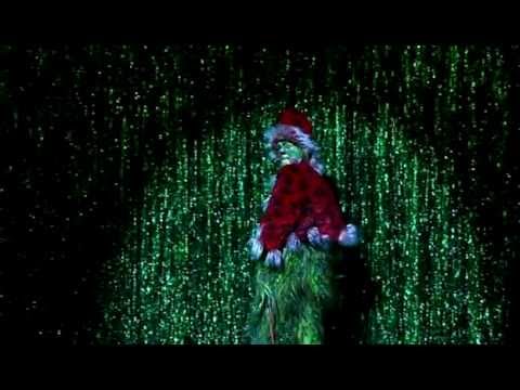 The Grinch on stage singing One of a Kind.