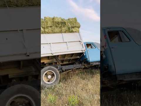 A TRUCK LOADED WITH BALES OVERTURNS