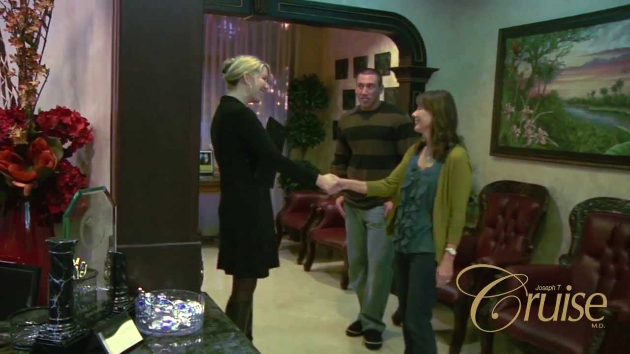 Three people greeting in a welcoming office setting.