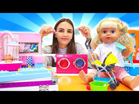 Baby Emily Doll has a new baby doll! Washing clothes in a toy washing machine. Dolls videos for kids