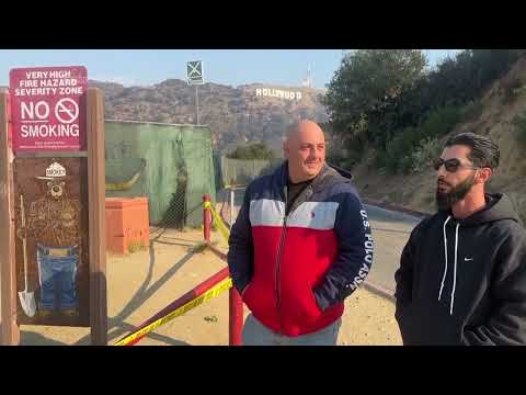 Locals check the Hollywood sign after seeing false reports of the iconic landmark burning