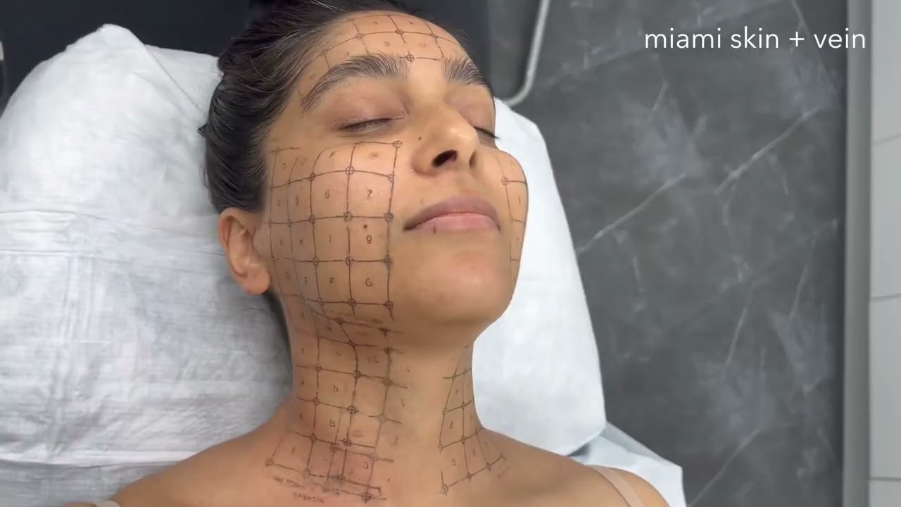 Woman receiving skincare treatment in clinical setting.