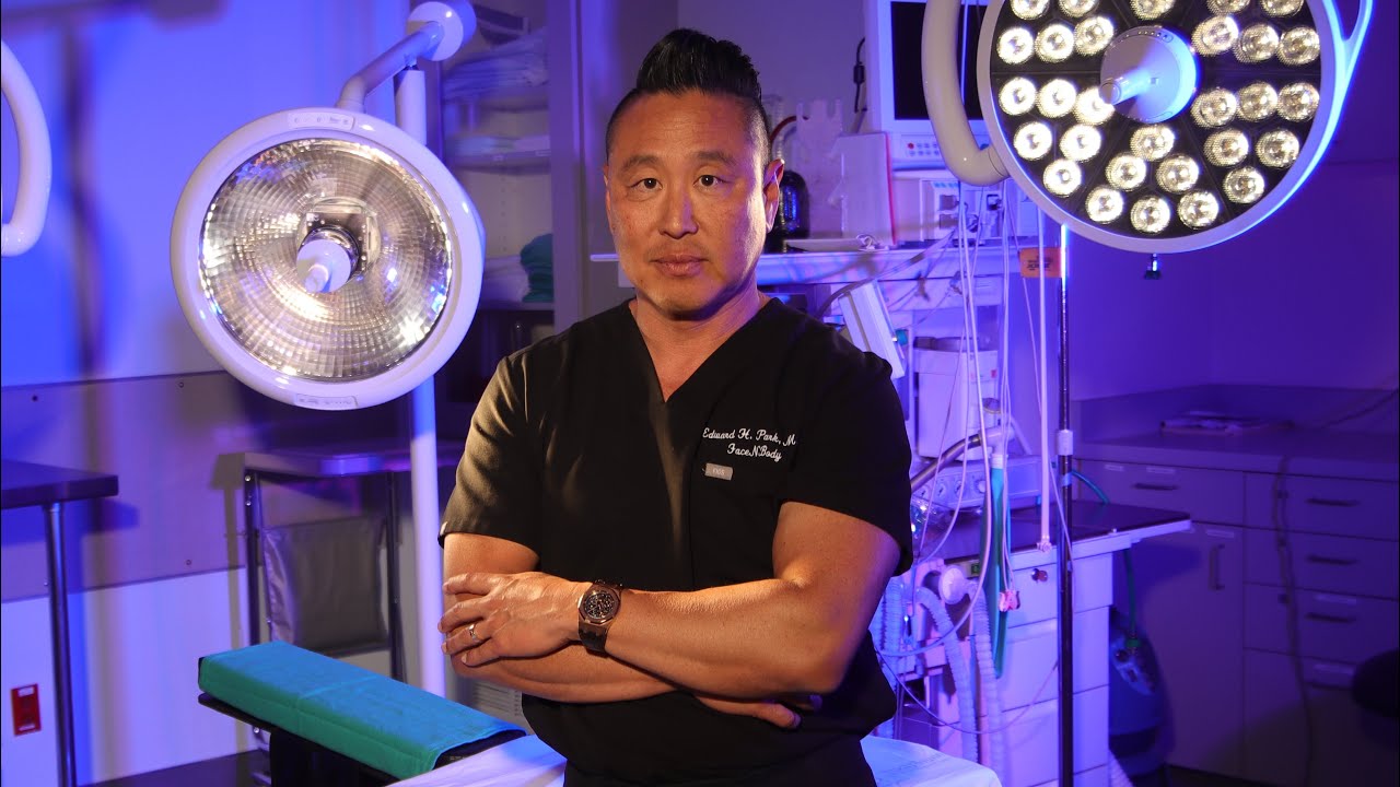 Surgeon in surgical room with operating lights.