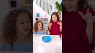 Sierra and Rhia both sharing a cookie with each other