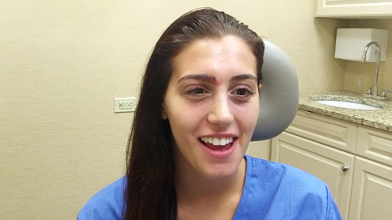 Smiling patient in a dental office setting.