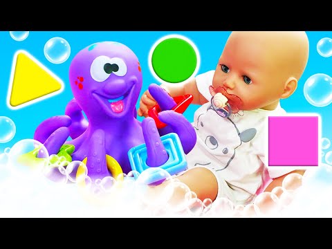 Baby Annabell doll bathtime & swimming in a bathtub. The baby doll plays with a toy octopus.