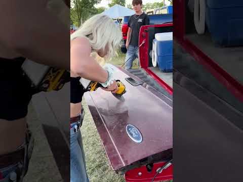 Signing a tail gate with an angle grinder,