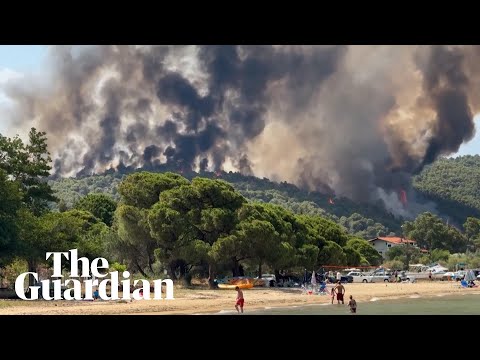 YouTube video thumbnail: Beachgoers on Greek Island Watch Wildfire Burn After Intense Heatwave