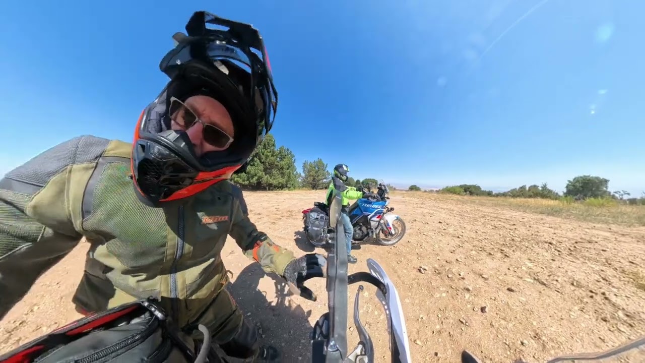 Two old guys ride ADV bikes slow up an easy hill.