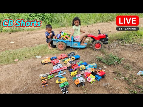 Yana and Oun Mey ride a tractor to find small cars on the road near their house again today