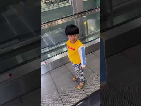 3 years baby trying to defeat fear on escalator and successfully rides after multiple falls #funny