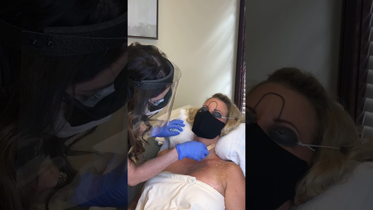 Client receiving facial treatment in beauty clinic.
