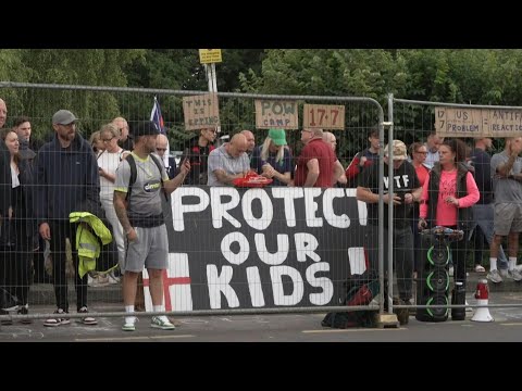 Protesters, police outside UK hotel housing asylum seekers | AFP